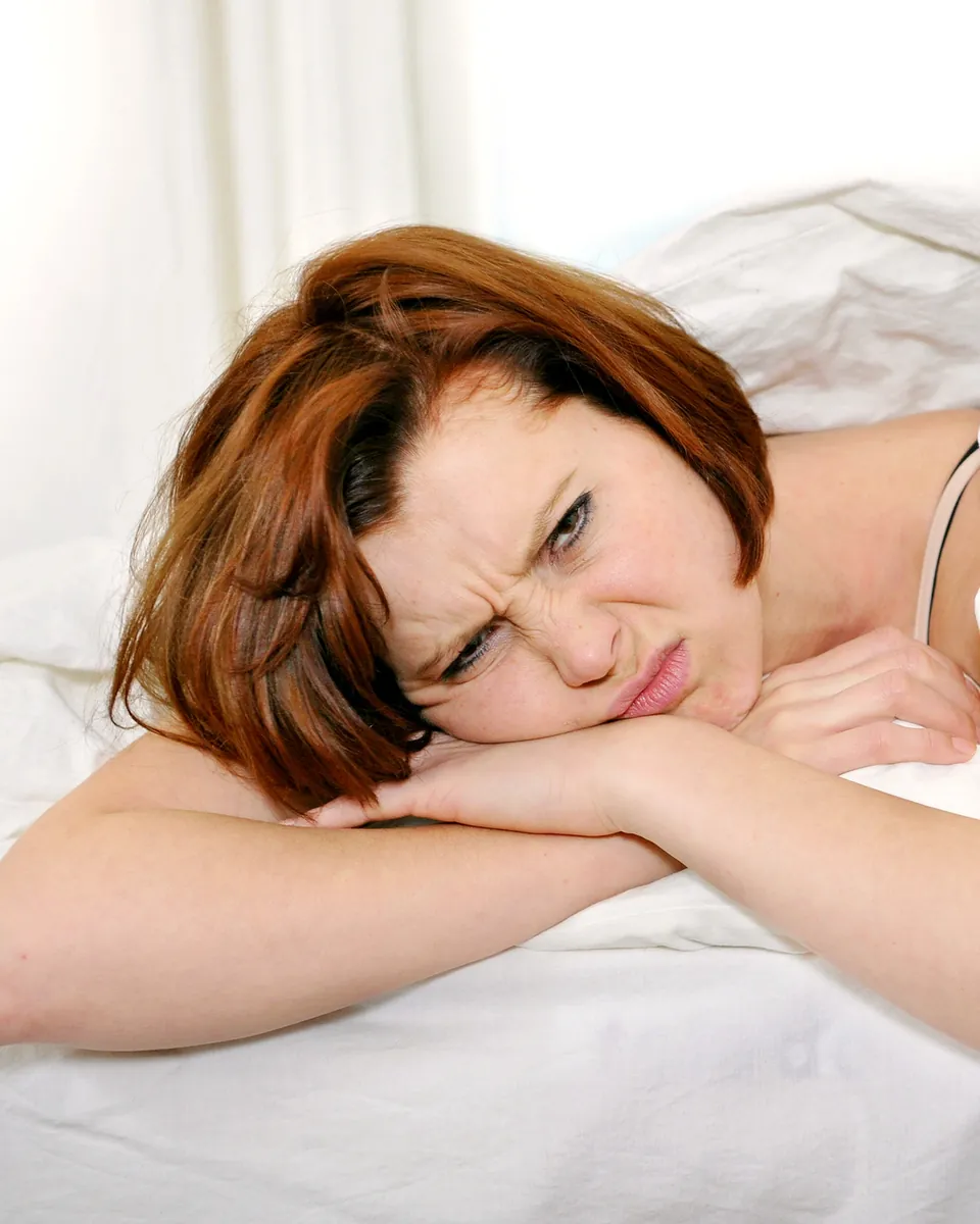 Woman resting in bed after a late night