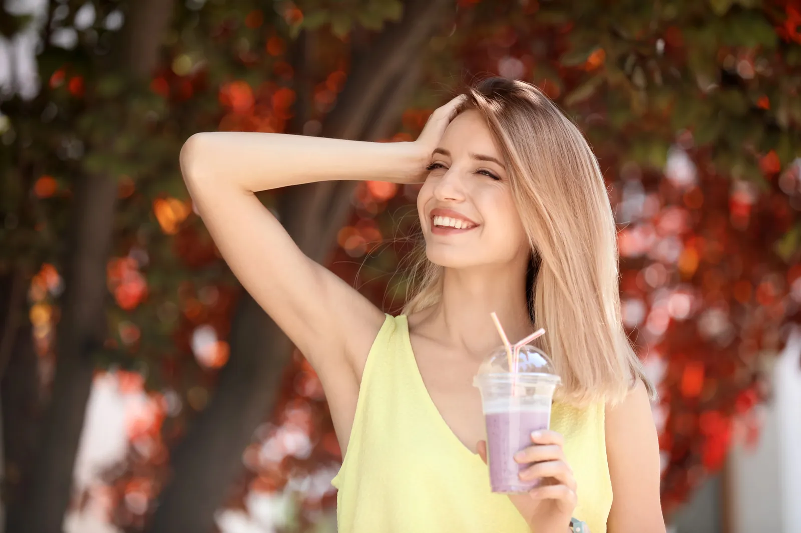 Smiling woman enjoying an autumn day outdoors